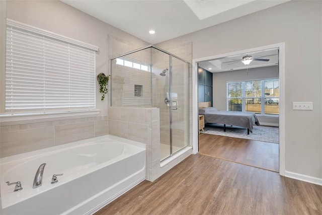 bathroom with wood-type flooring, shower with separate bathtub, and ceiling fan