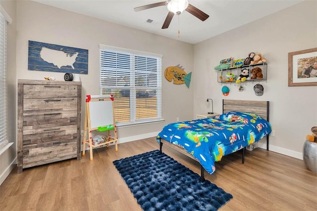 bedroom with wood-type flooring and ceiling fan