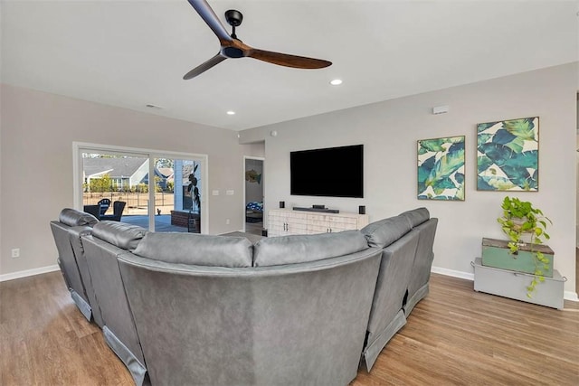 living room with ceiling fan and light hardwood / wood-style floors