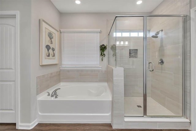 bathroom featuring separate shower and tub