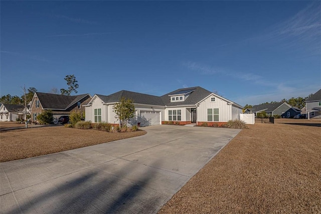 view of front of property with a garage and a front lawn