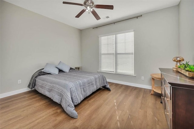 bedroom with ceiling fan and light hardwood / wood-style floors