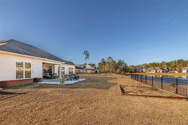 view of yard featuring a patio area and a water view