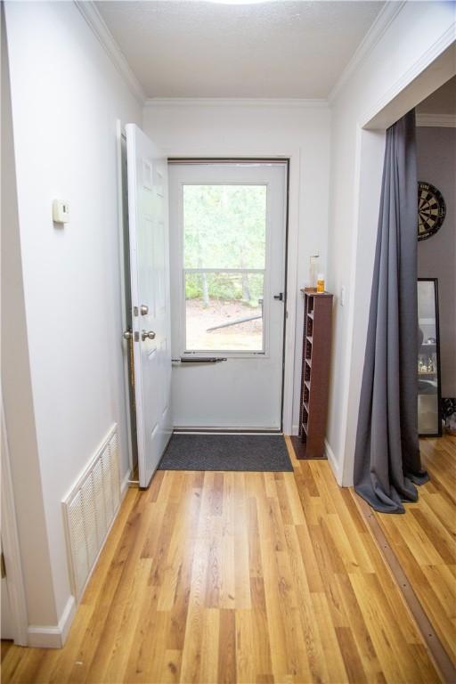 320 Brobston St, Baxley, GA 31513 - entryway with light wood-style floors and ornamental molding