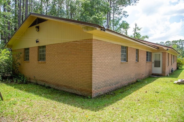 320 Brobston St, Baxley, GA 31513 - view of side of property featuring brick siding and a yard