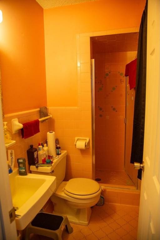 320 Brobston St, Baxley, GA 31513 - bathroom with tile patterned floors, a stall shower, tile walls, and wainscoting
