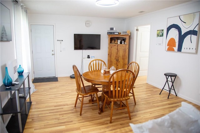 320 Brobston St, Baxley, GA 31513 - dining space with light wood-style flooring and ornamental molding