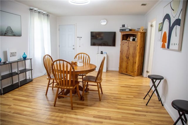 320 Brobston St, Baxley, GA 31513 - dining room with light wood-style floors and crown molding