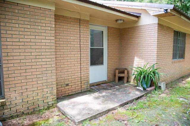 320 Brobston St, Baxley, GA 31513 - property entrance featuring brick siding and a patio area