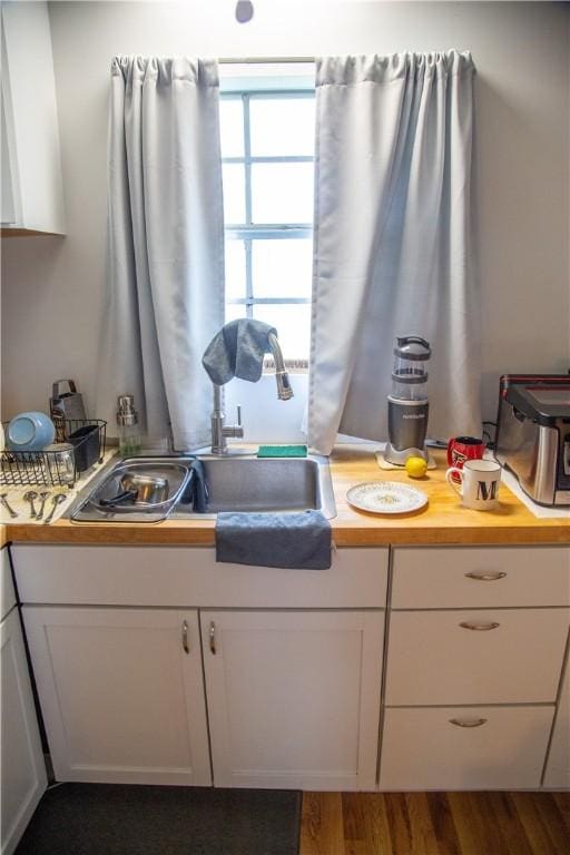 320 Brobston St, Baxley, GA 31513 - kitchen with white cabinetry and dark wood-type flooring