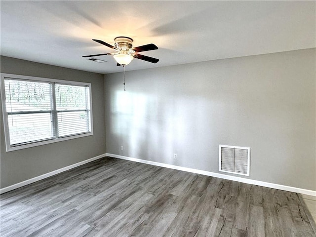 empty room featuring ceiling fan and hardwood / wood-style floors