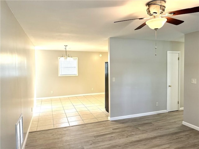 empty room with light hardwood / wood-style floors and ceiling fan