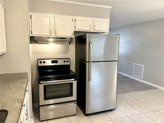 kitchen with light stone counters, white cabinets, appliances with stainless steel finishes, and light tile patterned flooring