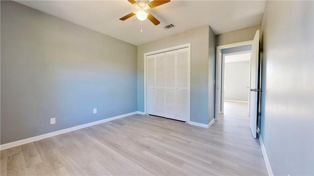 1301 Riverside Ave, Waycross, GA 31501 - unfurnished bedroom featuring light wood-style flooring, a closet, baseboards, and a ceiling fan