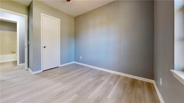 1301 Riverside Ave, Waycross, GA 31501 - unfurnished bedroom featuring light wood-type flooring and baseboards