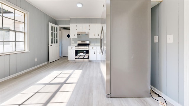 1301 Riverside Ave, Waycross, GA 31501 - kitchen featuring appliances with stainless steel finishes, under cabinet range hood, light wood-type flooring, and plenty of natural light