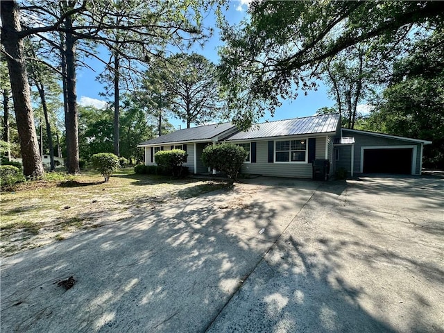1301 Riverside Ave, Waycross, GA 31501 - view of front of property with driveway, a garage, and metal roof