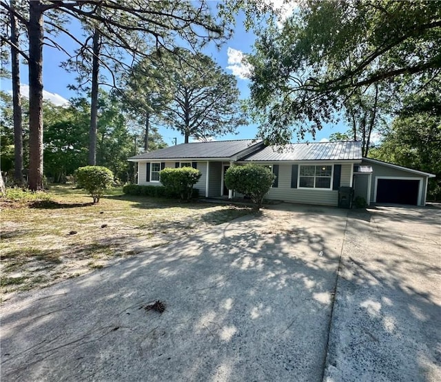 1301 Riverside Ave, Waycross, GA 31501 - ranch-style house featuring driveway, metal roof, and a garage