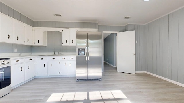 1301 Riverside Ave, Waycross, GA 31501 - kitchen with stainless steel fridge with ice dispenser, white range with electric cooktop, a sink, crown molding, and light wood-type flooring