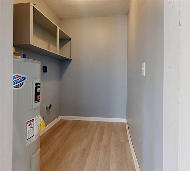 1301 Riverside Ave, Waycross, GA 31501 - clothes washing area with water heater, light wood finished floors, and baseboards