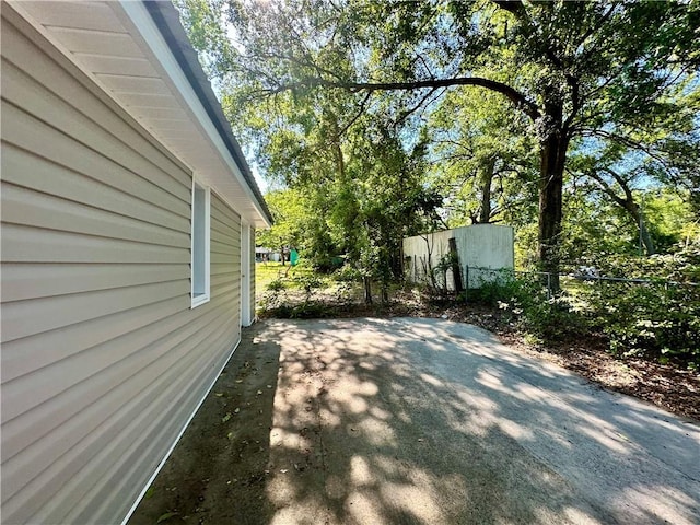 1301 Riverside Ave, Waycross, GA 31501 - view of side of home with fence and a patio area