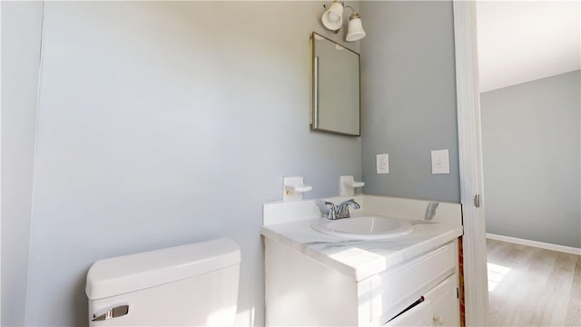 1301 Riverside Ave, Waycross, GA 31501 - bathroom with vanity, wood finished floors, and toilet