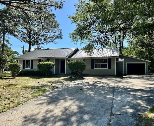 1301 Riverside Ave, Waycross, GA 31501 - ranch-style house with concrete driveway, an attached garage, metal roof, and a front lawn