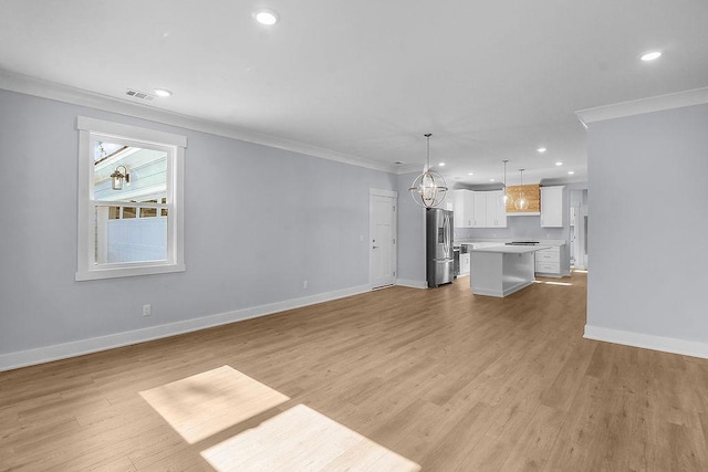 7383 Shellman Bluff Rd NE, Townsend, GA 31331 - unfurnished living room with ornamental molding, a chandelier, recessed lighting, and light wood-style flooring