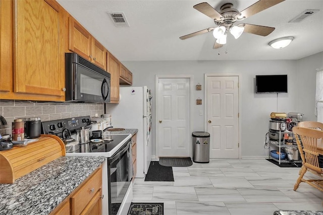 kitchen featuring ceiling fan, dark stone countertops, decorative backsplash, and black appliances