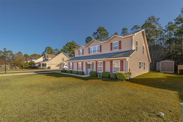 view of front of home with a porch, a shed, and a front yard