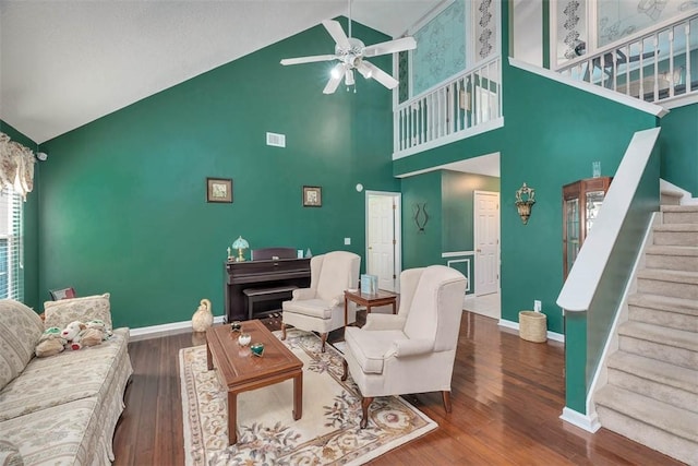 living room with hardwood / wood-style flooring, vaulted ceiling, and ceiling fan