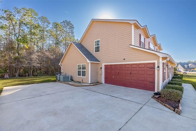 view of property exterior featuring a garage and central air condition unit