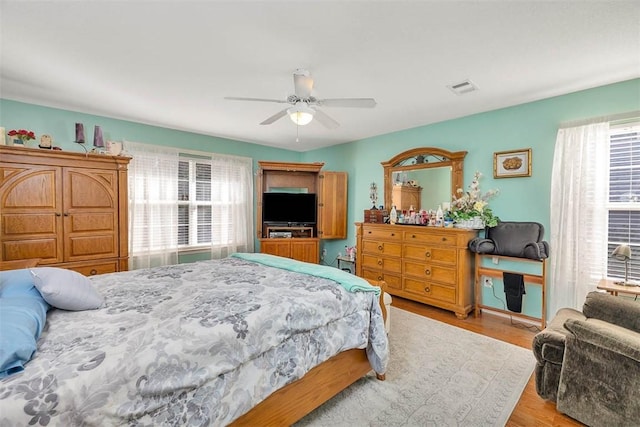 bedroom with ceiling fan and light hardwood / wood-style floors