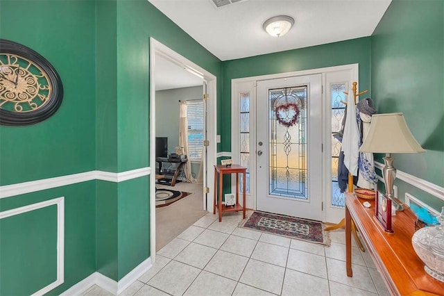 entryway with light tile patterned floors