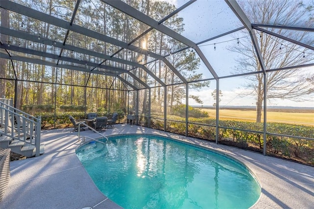 view of swimming pool with a patio and glass enclosure