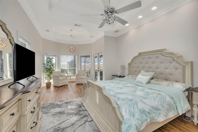 sitting room featuring hardwood / wood-style flooring, a tray ceiling, an inviting chandelier, and french doors