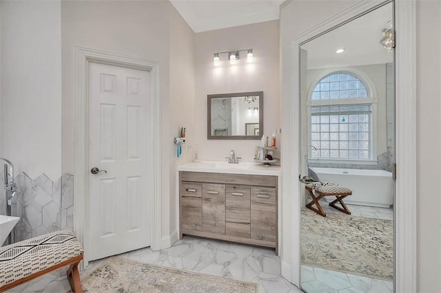 bathroom featuring vanity and a tub