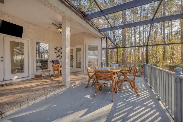 sunroom featuring vaulted ceiling and ceiling fan