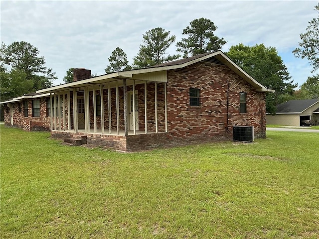 2608 Winchester Dr, Waycross, GA 31501 - view of property exterior with a chimney, brick siding, and a yard