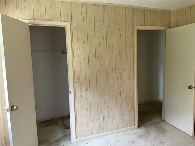 2608 Winchester Dr, Waycross, GA 31501 - unfurnished bedroom with wooden walls, a closet, and a spacious closet