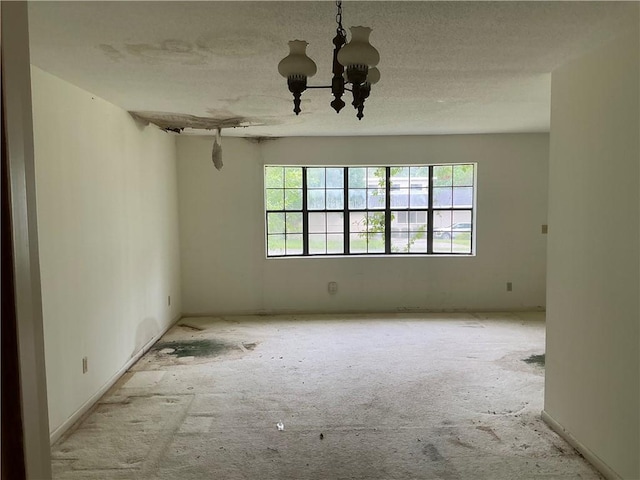 2608 Winchester Dr, Waycross, GA 31501 - spare room featuring a chandelier and a textured ceiling