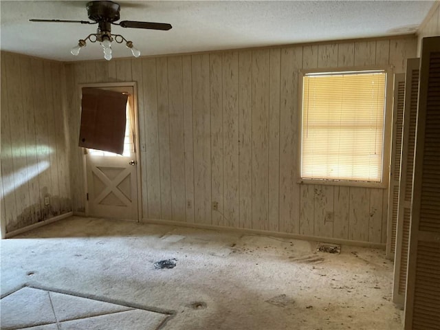 2608 Winchester Dr, Waycross, GA 31501 - carpeted empty room featuring a ceiling fan and wood walls