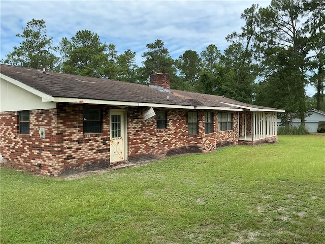 2608 Winchester Dr, Waycross, GA 31501 - rear view of property with a chimney, a lawn, and brick siding