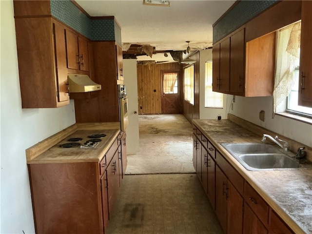 2608 Winchester Dr, Waycross, GA 31501 - kitchen featuring under cabinet range hood, brown cabinets, electric stovetop, and oven