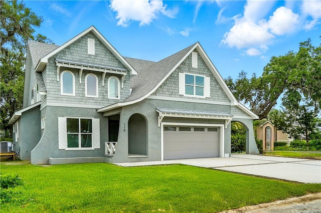 110 Pirates Cv, Saint Simons Island, GA 31522 - view of front of house with concrete driveway, a front yard, stucco siding, and a garage