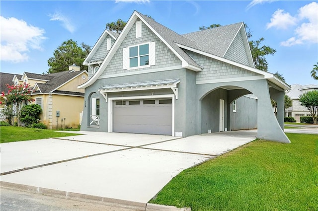 110 Pirates Cv, Saint Simons Island, GA 31522 - view of front of property with driveway, an attached garage, a front yard, and stucco siding