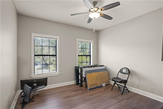 sitting room featuring a textured ceiling, ceiling fan, and dark hardwood / wood-style floors