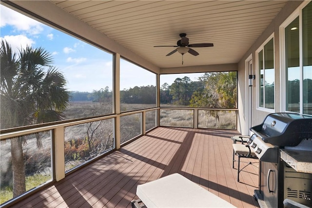 wooden terrace with area for grilling and ceiling fan