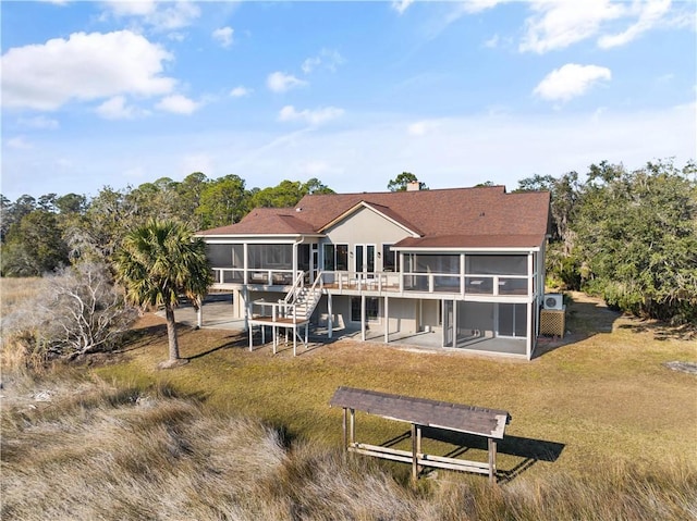 back of house featuring a sunroom and a patio area