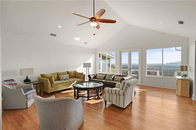 living room with ceiling fan, light wood-type flooring, and lofted ceiling